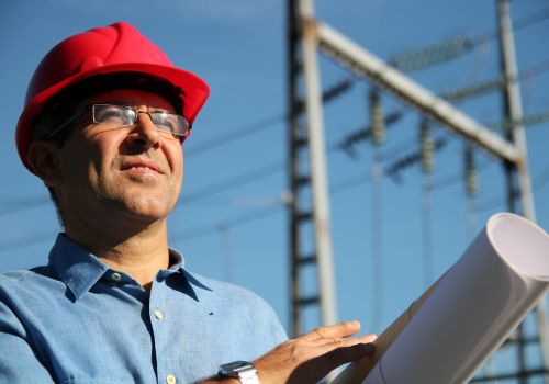 Electrical manager holding blueprints